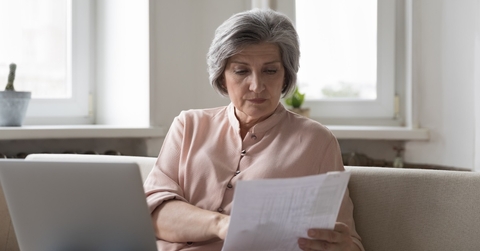 senior woman reviewing taxes at home