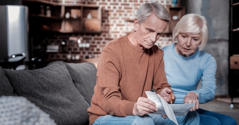 concentrated  woman pointing at document