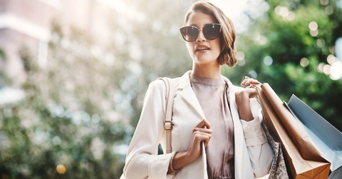woman holding shopping bags in street