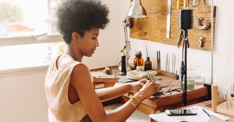 woman making handmade jewelry