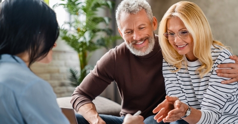 senior couple consulting female finance advisor