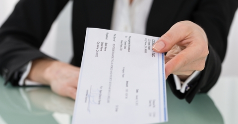 businesswoman hand giving cheque