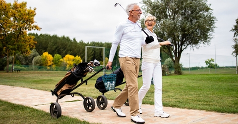 senior couple playing golf