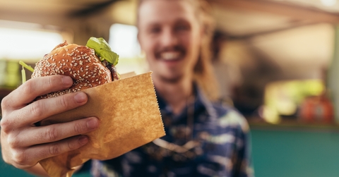 man offering a food truck burger
