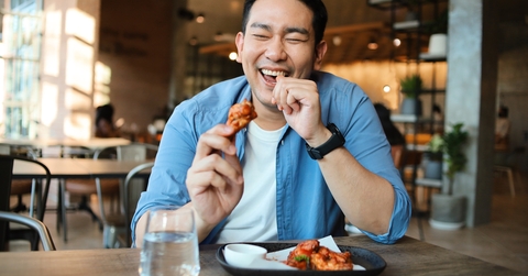 man eating bbq chicken wings