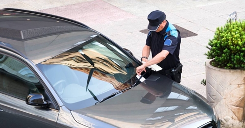 police writing parking ticket
