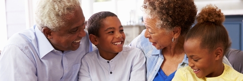 Grandparents with grandchildren relaxing at home