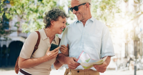 Retired couple tourist walking around town