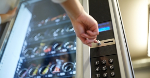 person buying food from vending machine