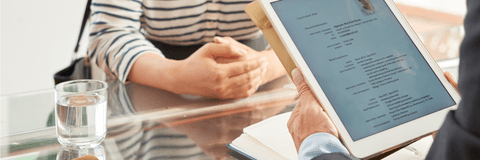 Businessman reading resume of woman