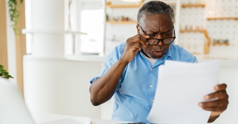 amazed pensioner looking at bills