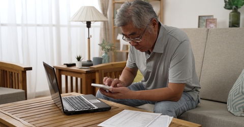 man counting on calculator
