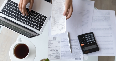 bills calculator and laptop on table
