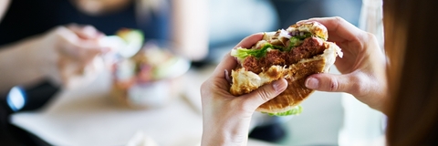 eating vegan meatless burger