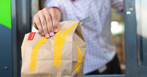 McDonald's worker holding fast food bag