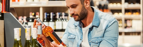 holding a bottle of wine