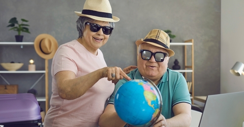 excited retired couple planning holiday trip