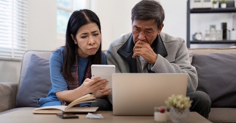 asian couple worried about bill