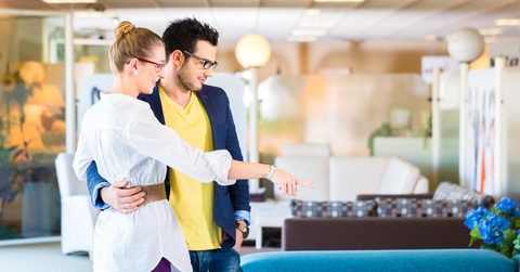 Couple buying couch in furniture store