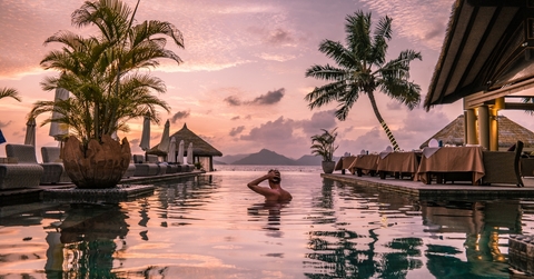 man at beach on tropical vacation
