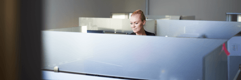 Woman in office working in cubicle
