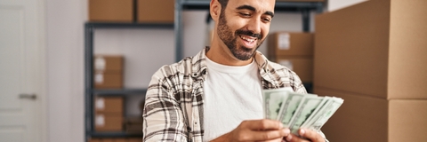 Worker counting dollars at office