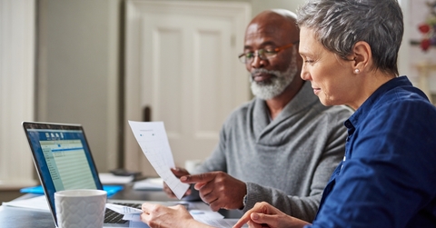 african american senior couple reviewing bills