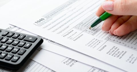 Female hands filling tax form