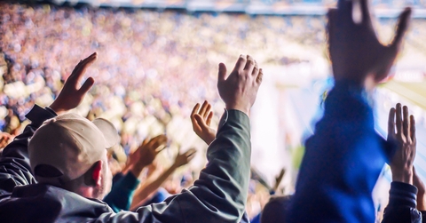 Football fans clapping on the podium