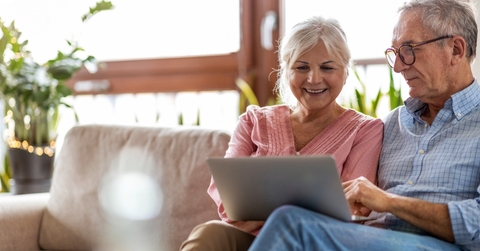senior couple reviewing taxes using laptop