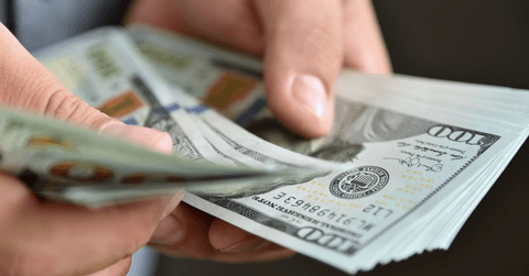 Close up of businessman counting money in hands