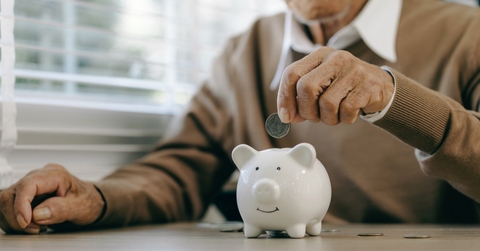 old man putting money coins 
