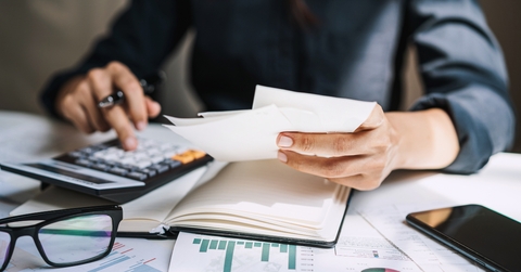 Stressed woman checking bills