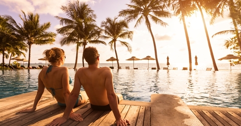 couple enjoying beach vacation at tropical resort 