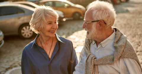 elderly couple holding hands
