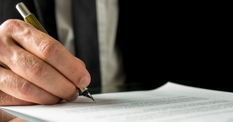 businessman signing a document