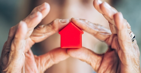 woman holding miniature house sculpture property concept