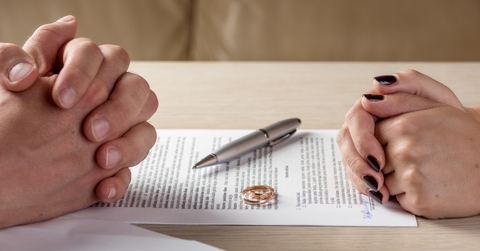 husband wife signing divorce documents