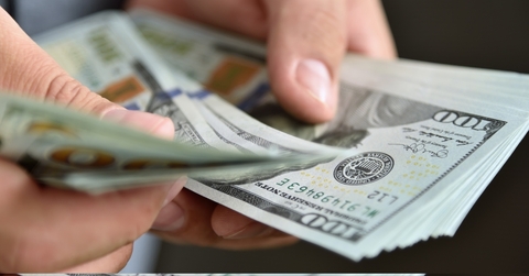 businessman counting banknotes in hand