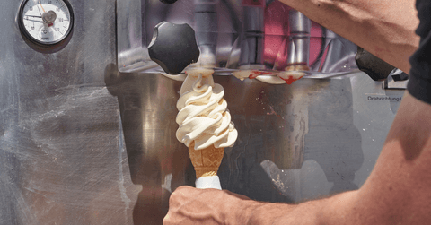 Vanilla ice cream cone and soft serve machine