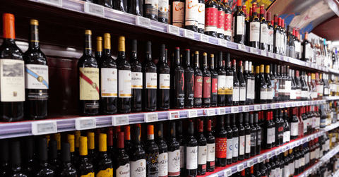 Shelves with wine at beverage section of supermarket
