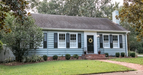 old blue cottage style house with sidewalk