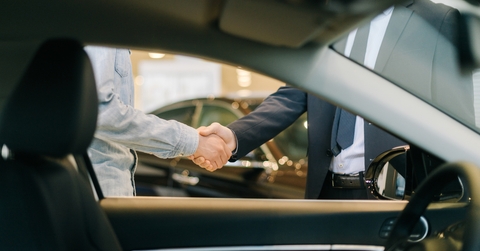 Buyer of car shaking hands