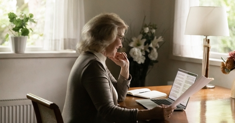 middle aged woman checking paper