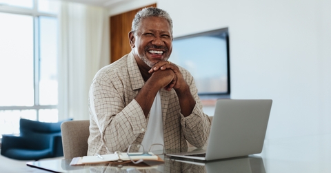 senior man working on laptop at home office