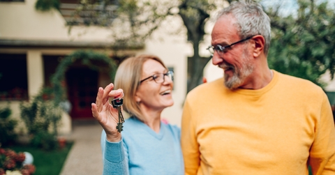 senior couple holding keys