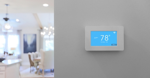 Home with smart thermostat mounted on wall