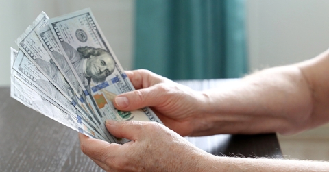 elderly woman with us dollars