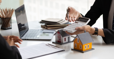 real estate agent holding a calculator