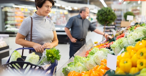 female customer selects savoy cabbage